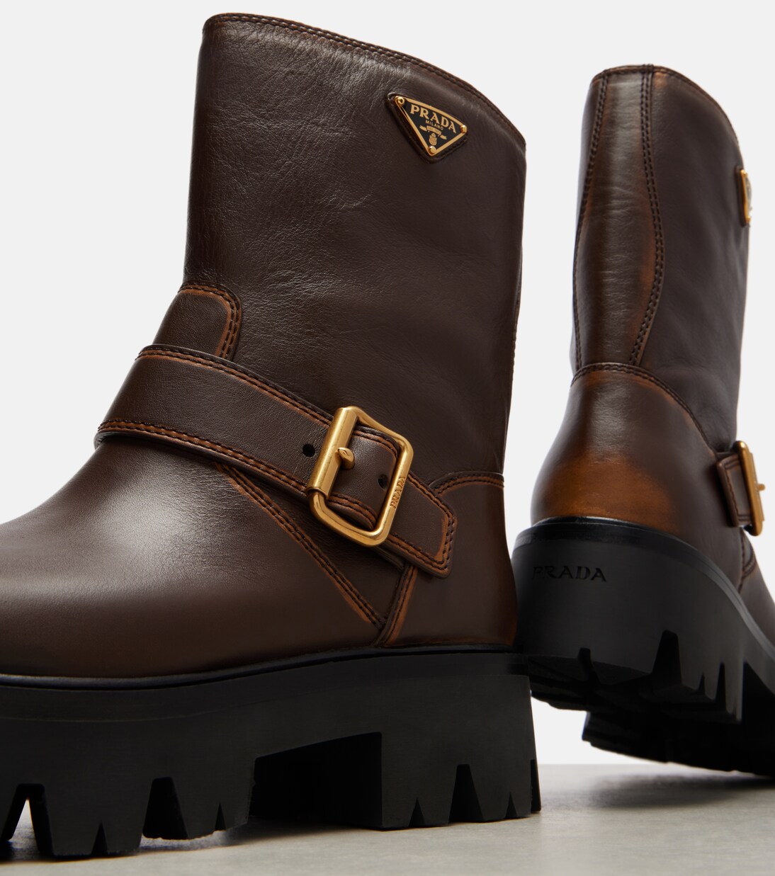 Logo leather biker boots in brown - Prada | Mytheresa