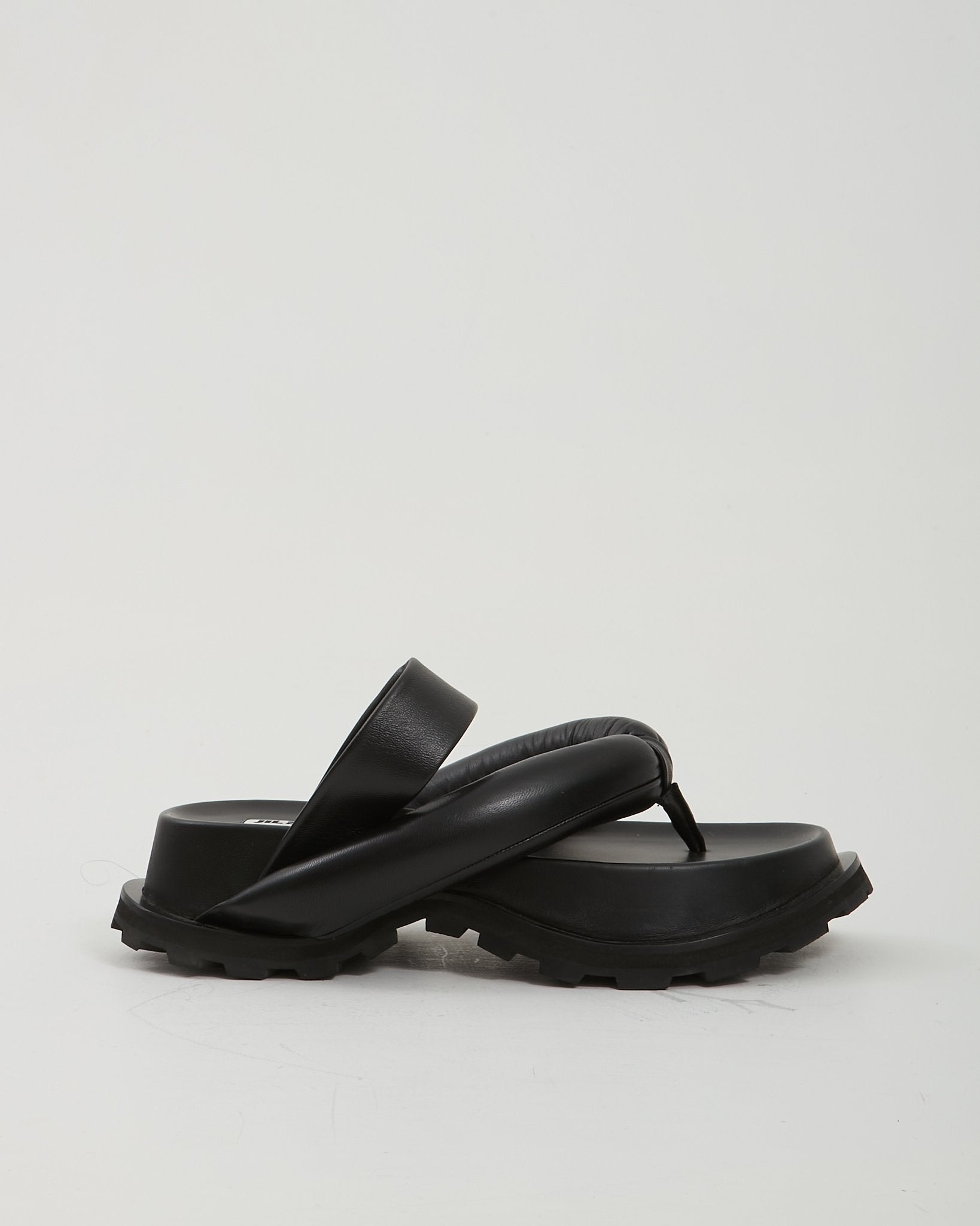 Explore a Jil Sander Black Leather Large Padded Thong Sandals - 36