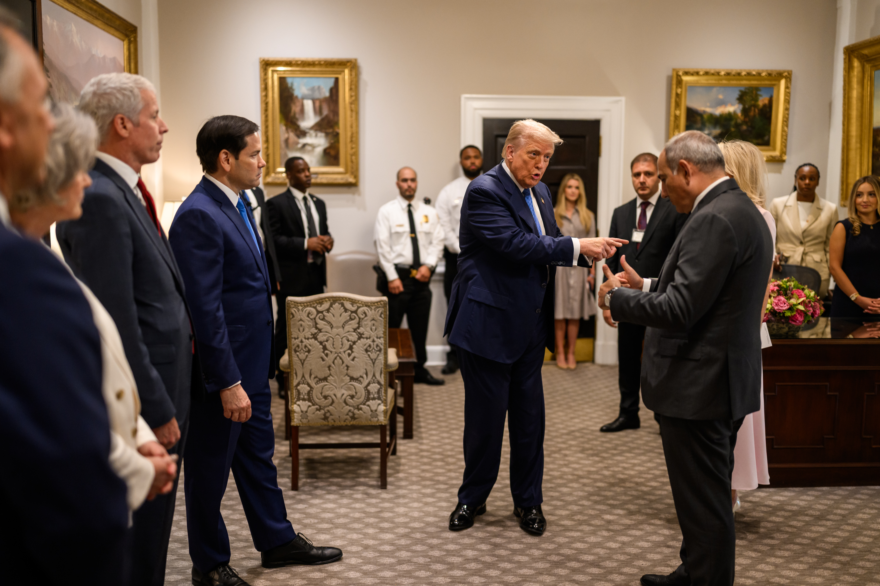 President Donald Trump signs a trilateral joint declaration with