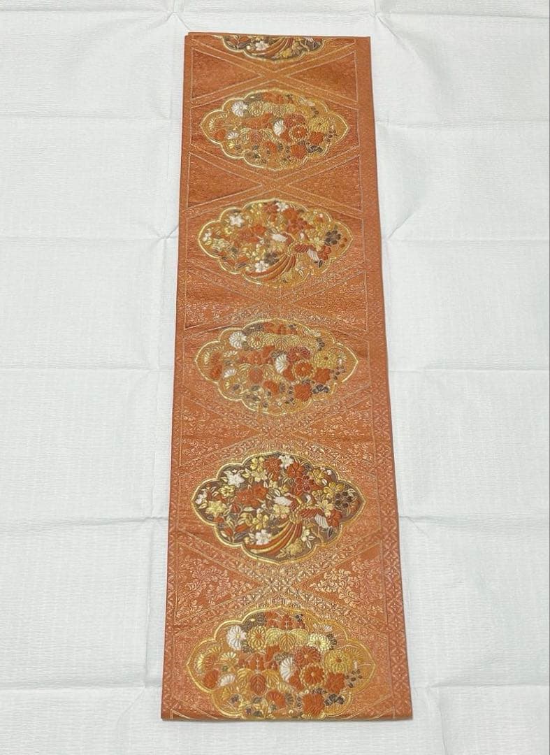 梅垣織物 袋帯 西陣織 七宝菱蒔絵文 正絹 金糸 オレンジゴールド系